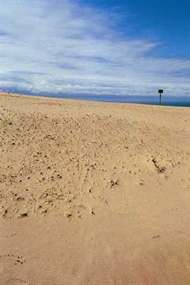 The sign says something like “Danger! Sliding sand beyond this point.